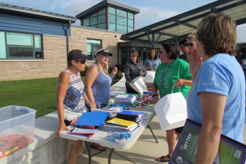 Cape staff members at Love Creek Elementary receive Caravan of Caring donations of school supplies. SUBMITTED PHOTO